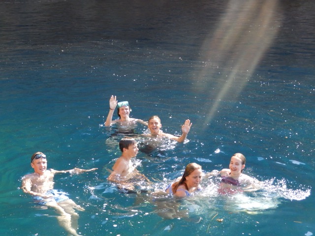 Koupajíci se žáci v místni laguně s průzrač. vodou